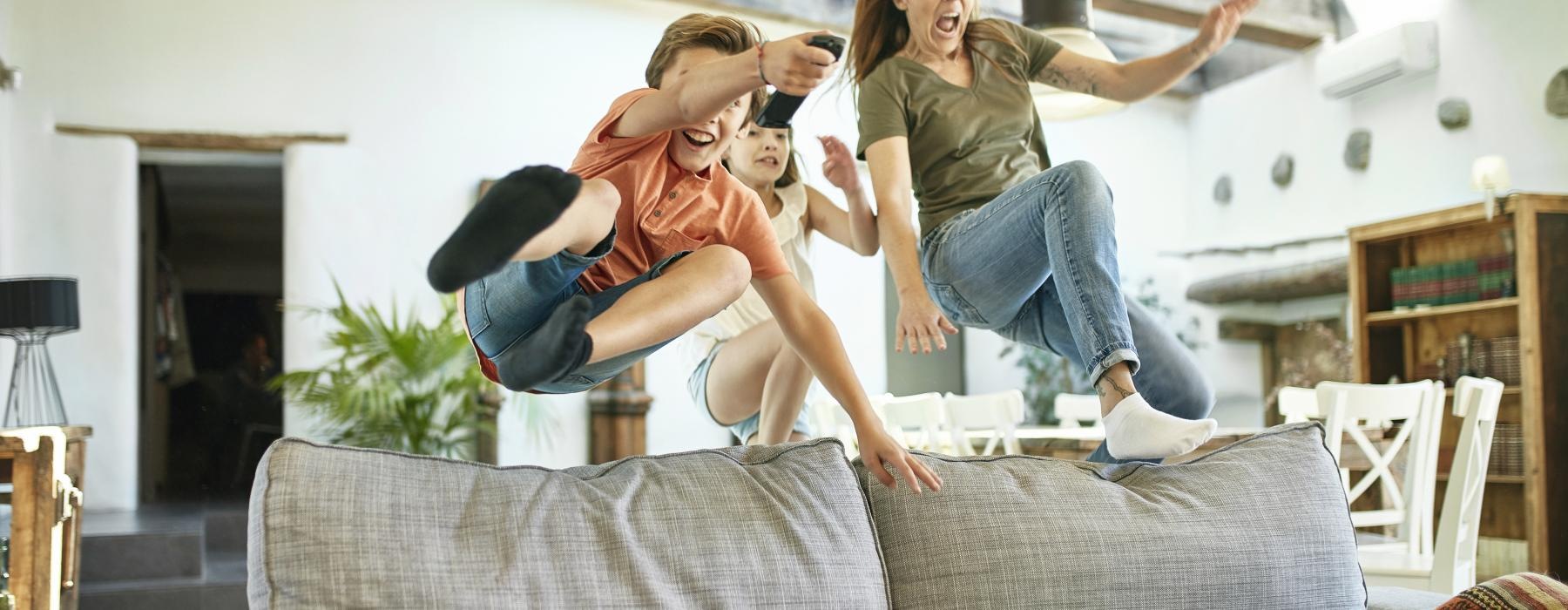 a group of people jumping on a couch